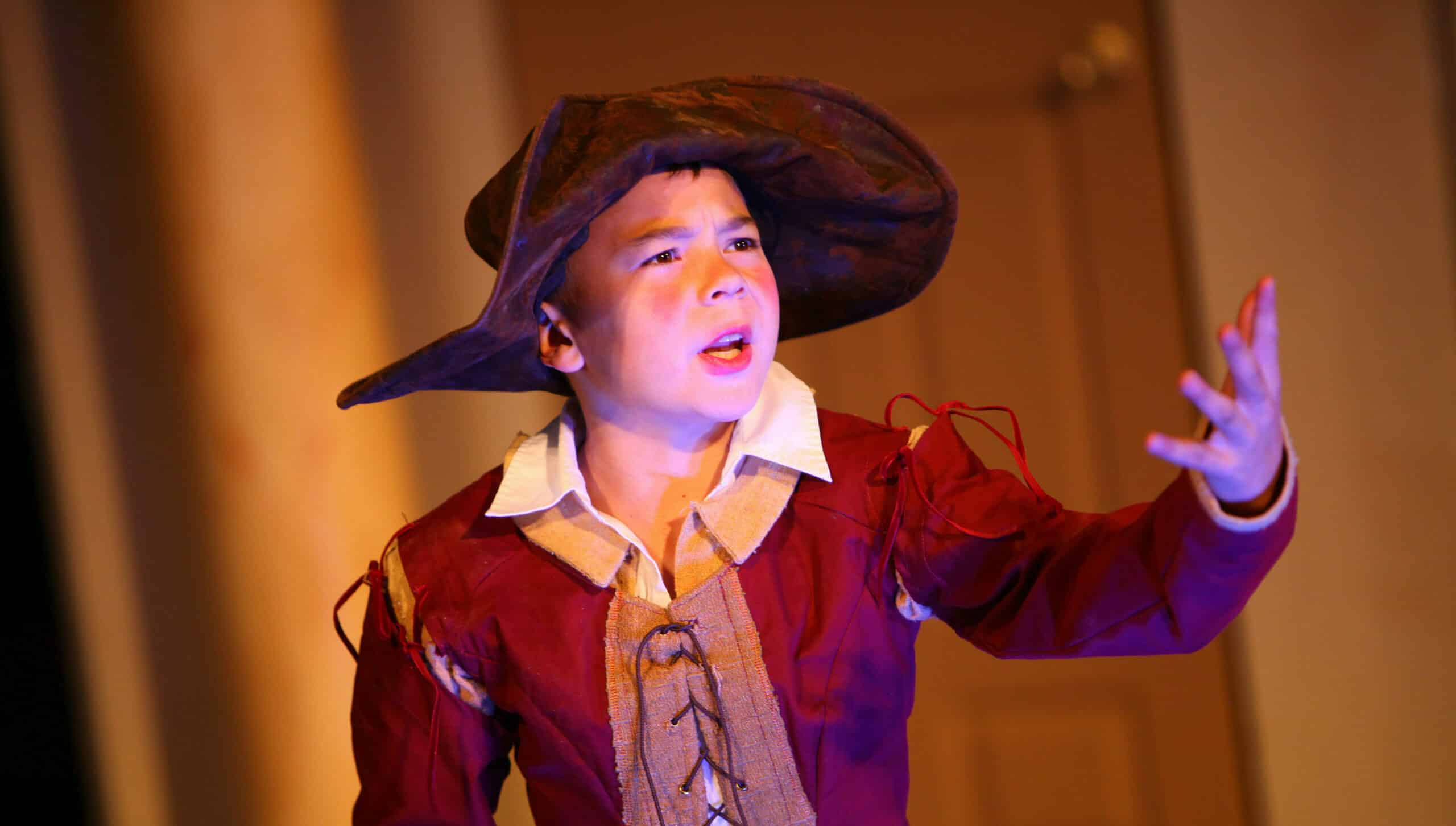 child in Shakespearian costume acting on stage
