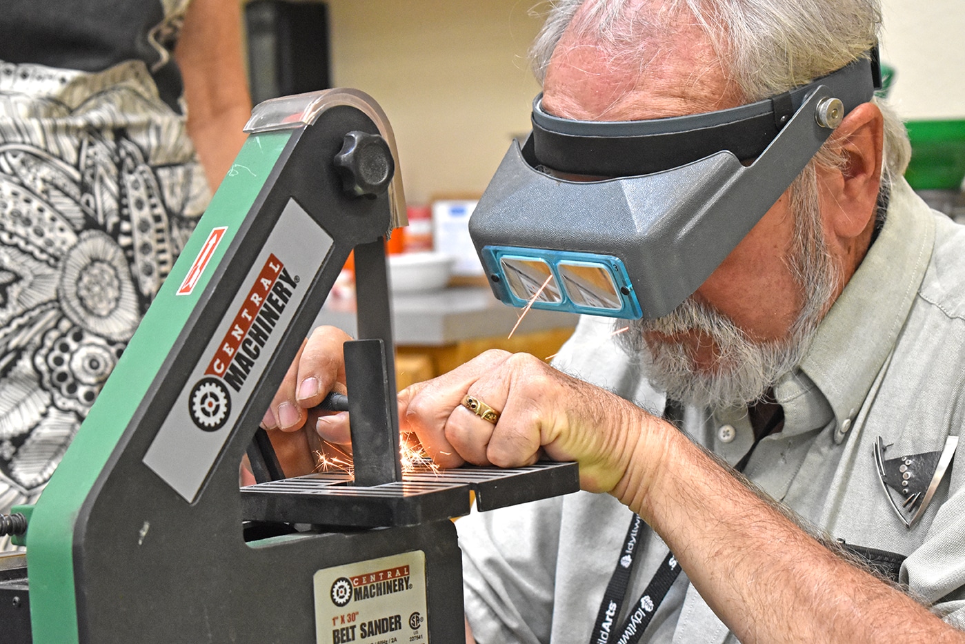 metalsmith at a machine